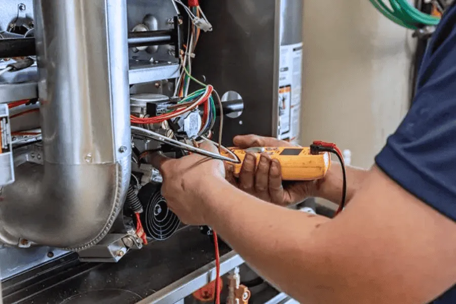 Technician testing furnace with tools